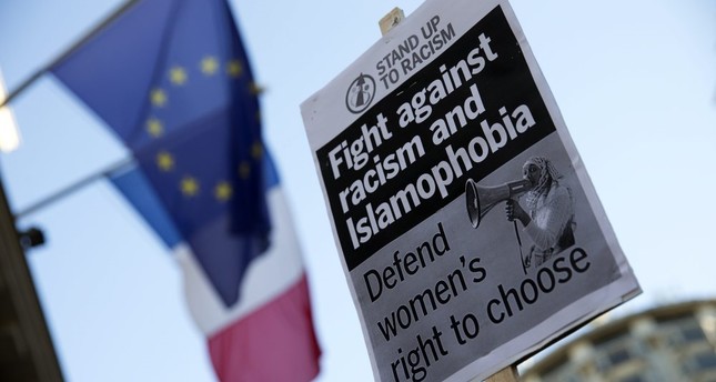 A placard held by a demonstrator at a protest against the Burkini ban on French beaches, outside the French Embassy in London, Aug. 26, 2016.