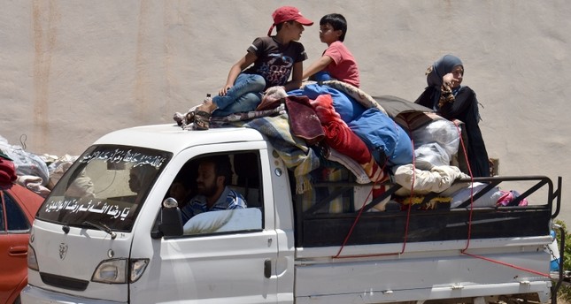 Displaced Syrians from the Daraa province come back to their hometown in Bosra, southwestern Syria, on July 11, 2018. (AFP Photo)