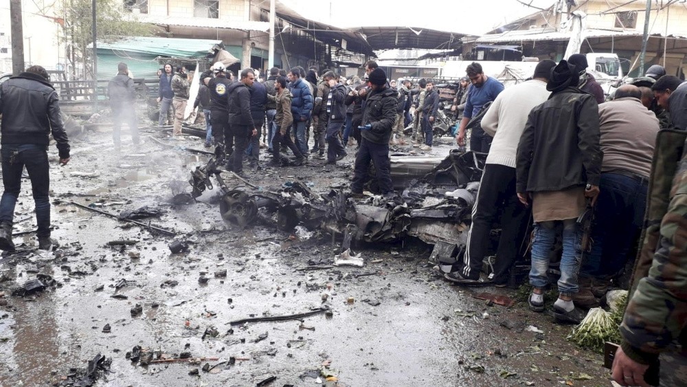 People gather around the Afrin city center, which was targeted by two bombs that killed 10 people and injured others 18, Jan. 20, 2019.