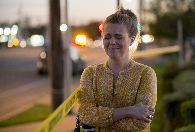 Caity Colvard gets emotional as she watches a massive response of law enforcement officers at a bomb explosion site at a Goodwill store in Austin, Texas, on Tuesday March 20, 2018. (AP Photo)
