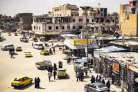 People walk along a market street in the northern Syrian city of Raqa, April 14, 2019.