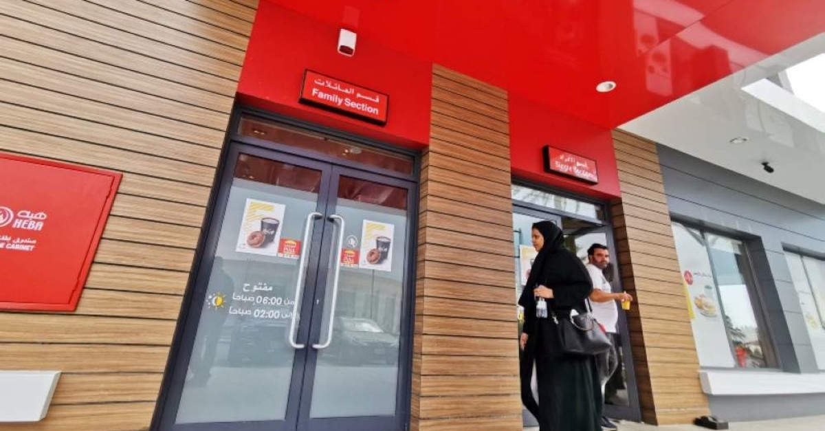 A Saudi woman walks towards the 'family section' while a man comes out of the 'single section' at McDonald's outlet in Khobar, Saudi Arabia, Dec. 9, 2019. REUTERS/ Hamad I Mohammed