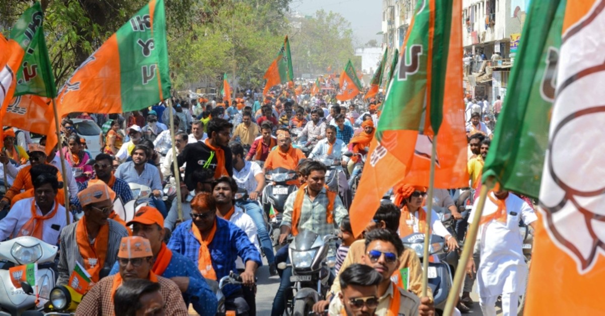 Indian Bharatiya Janta Party (BJP) supporters gather to follow BJP National President Amit Shah during his road show in Ahmedabad on April 6, 2019. (AFP Photo)