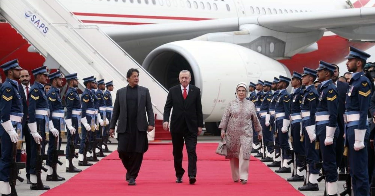 President Recep Tayyip Erdo?an (C), First Lady Emine Erdo?an (R) and Pakistan's Prime Minister Imran Khan walk on the president's arrival in Islamabad, Pakistan, Feb. 13, 2020. (AA Photo)