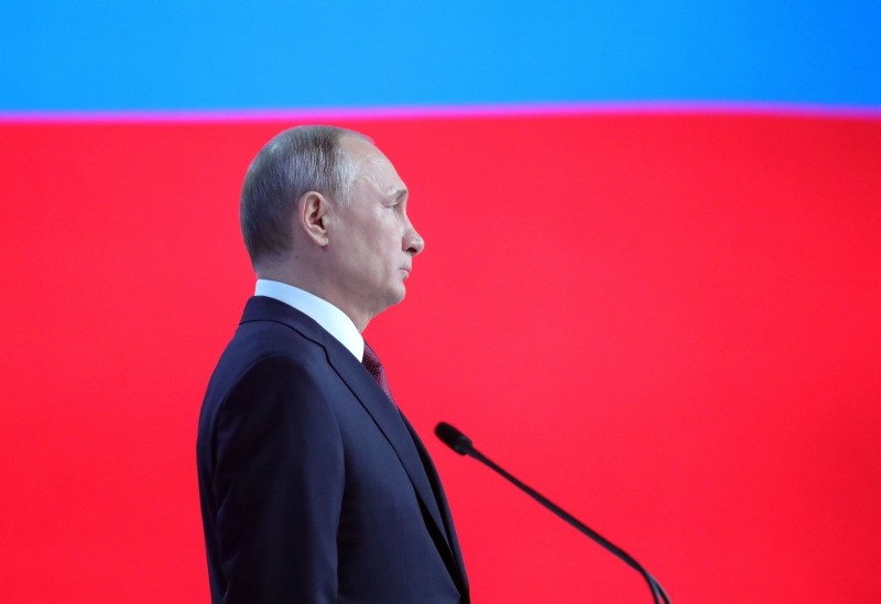Russian President Vladimir Putin, officials and other attendees listen to the national anthem at the end of Vladimir Putin's annual state of the nation address in Moscow on February 20, 2019. (AP Photo)