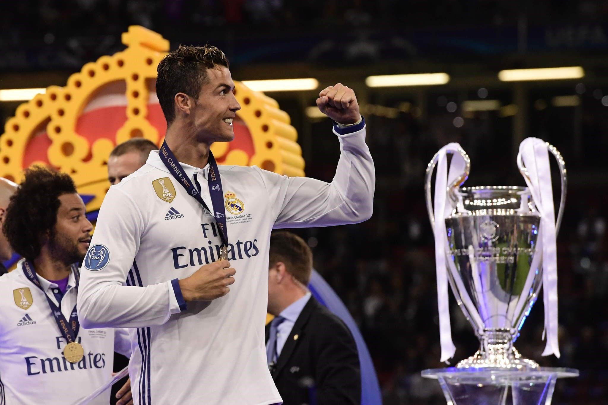 Ronaldo celebrates next to the trophy after Real Madrid won the UEFA Champions League final in Cardiff.