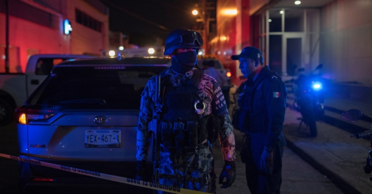 Federal forces keep watch at a crime scene following a deadly attack on a bar by unknown assailants in Coatzacoalcos, Mexico, Aug. 28, 2019. (AP Photo)