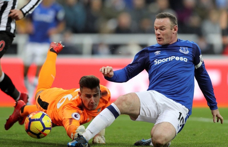 Everton's Wayne Rooney, right, in close action with Newcastle goalie to score his side's first goal of the game, during their English Premier League soccer match at St James' Park in Newcastle, England, Wednesday Dec. 13, 2017. (AP Photo)