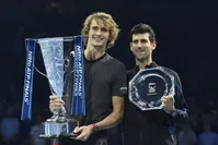 Alexander Zverev (left) and Novak Djokovic pose with their awards.