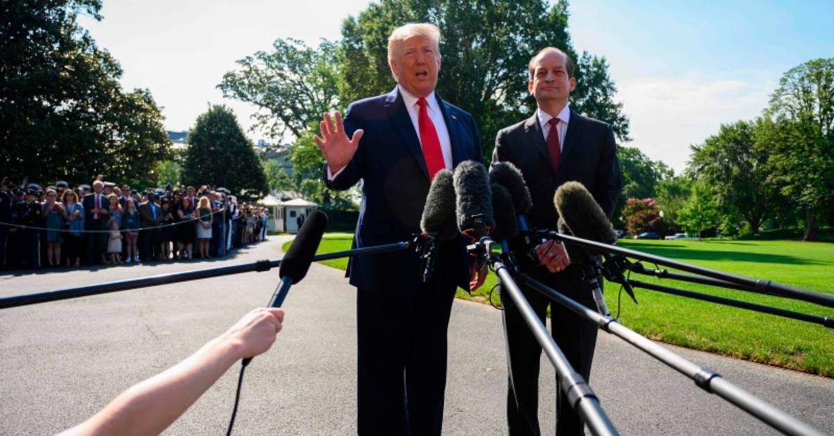 US President Donald Trump (L) gestures as US Labor Secretary Alexander Acosta looks as they speak to the media on July 12, 2019 at the White House in Washington, DC. (AFP Photo)