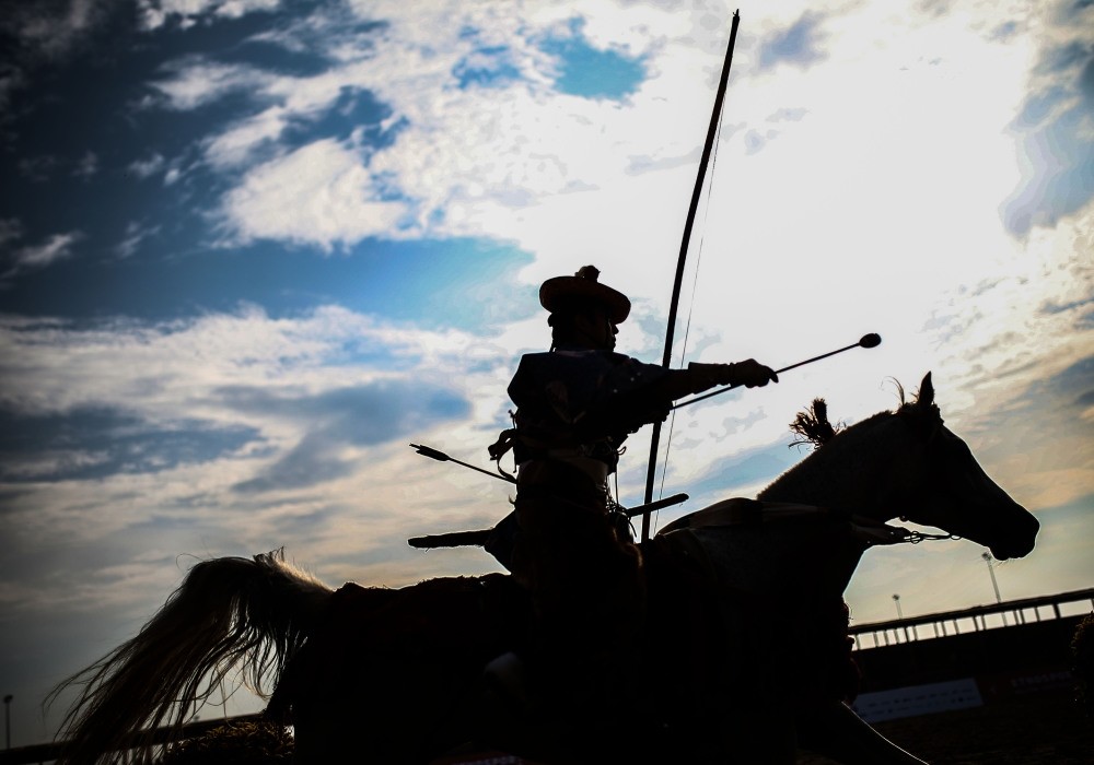 A Japanese archer performs yabusame, a type of mounted archery, at the Ethnosports venue.