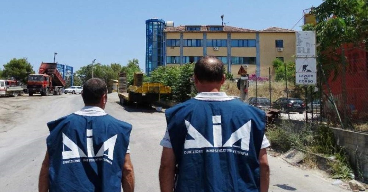 Anti-mafia department (DIA) police officers walk through a seized firm, Palermo. (AFP Photo)