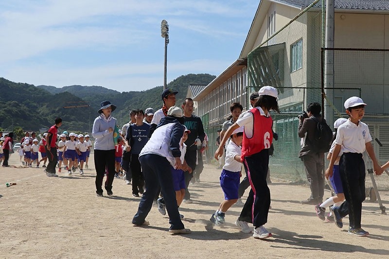 Schoolchildren are led by teachers toward a gymnasium during an evacuation drill at the Abu elementary school in Abu town, Yamaguchi prefecture. (AFP Photo)