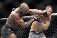 Jon Jones (L) connects a punch on Dominick Reyes during the bout at UFC 247, Feb. 9, 2020. (AP Photo)