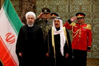 Iran's President Hassan Rouhani stands next to Emir of Kuwait Sheikh Sabah al-Ahmad al-Sabah during a welcoming ceremony in Kuwait City, Kuwait, Feb. 15.