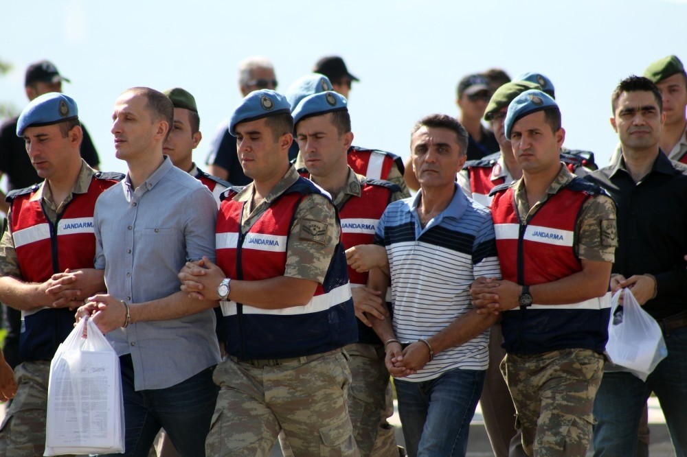 Gendarmerie troops escort defendants to court.