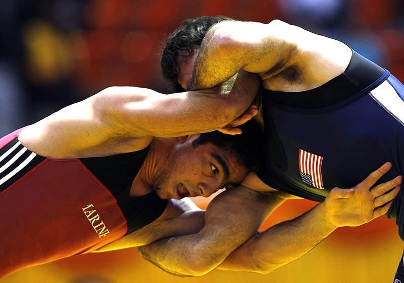 Iranian Mostafa Hossein-Khani (L) wrestles with US Michael Zadik (R) in the 66kg freestyle category at the 29th International Takhti Cup wrestling tournament in Tehran on March 12, 2009. (AFP Photo)