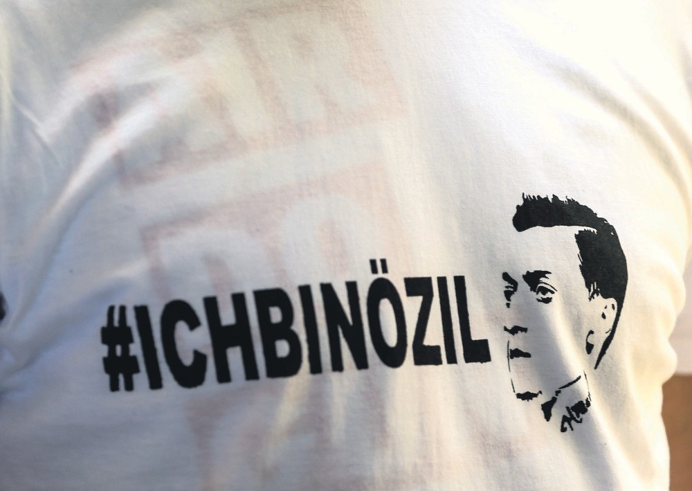 A T-shirt bearing the words ,I am u00d6zil, is worn by a protester during a demonstration against the German government's treatment of international football star Mesut u00d6zil, Germany.