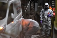 Members of the armed forces in protective suits investigate a property in Winterslow, Britain, after former Russian spy Sergei Skripal and his daughter were attacked with a nerve agent.