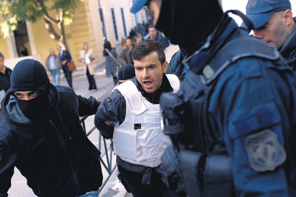 Police escort DHKP-C suspects to the prosecutor's office in Athens. 