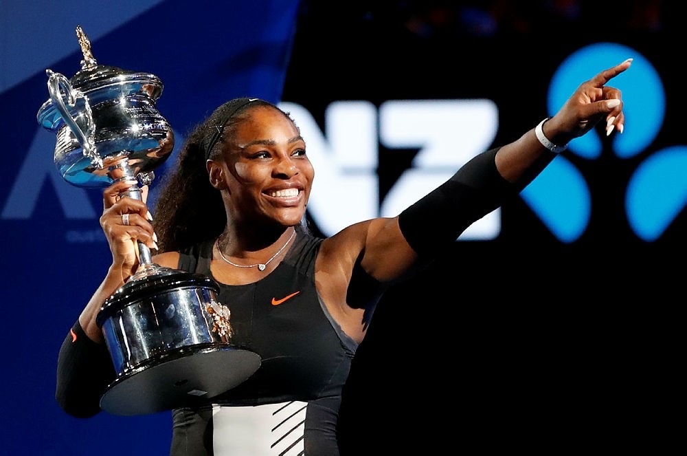 Williams holds her trophy after defeating her sister Venus during the women's singles final at the Australian Open tennis championships in Melbourne, Australia. (AP Photo)