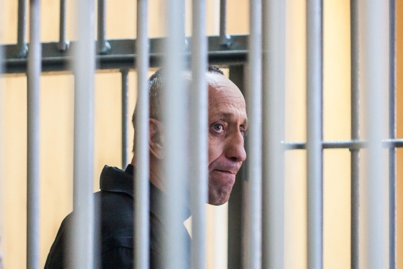 Mikhail Popkov stands inside a defendants' cage during a court hearing in Irkutsk, Russia, Dec. 10, 2018. (AFP Photo)