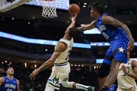 Orlando Magic's Markelle Fultz fouls Milwaukee Bucks' George Hill as he shoots during the second half of the game, Milwaukee, Dec. 9, 2019. (AP Photo)