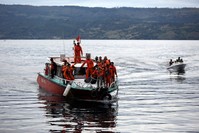 Indonesian rescue team members carry the body of a victim on a boat near Tigaras Port, Simalungun, North Sumatra, Indonesia, June 20, 2018. (EPA Photo)