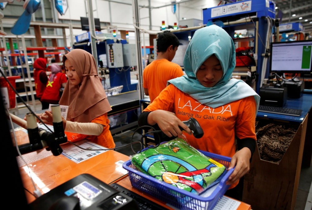 Workers package items for delivery at online retailer Lazada's warehouse in Depok, south of Jakarta, March 26.
