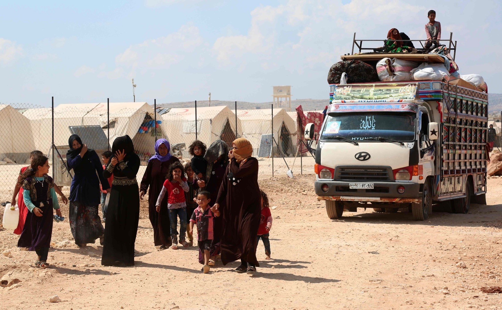 Displaced Syrians arrive with their belongings to a camp in Kafr Lusin, near the border with Turkey in the northern part of Syriau2019s Idlib province, Sept. 9.