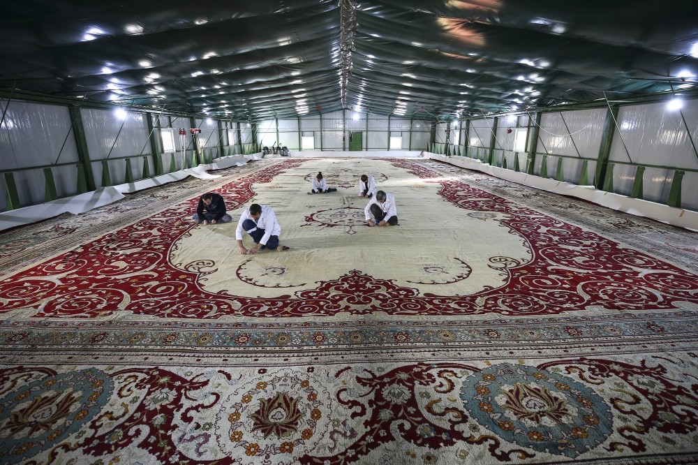 Restoration crew works on the 120-year-old carpet in a warehouse set up in the courtyard of Yu0131ldu0131z Chalet.