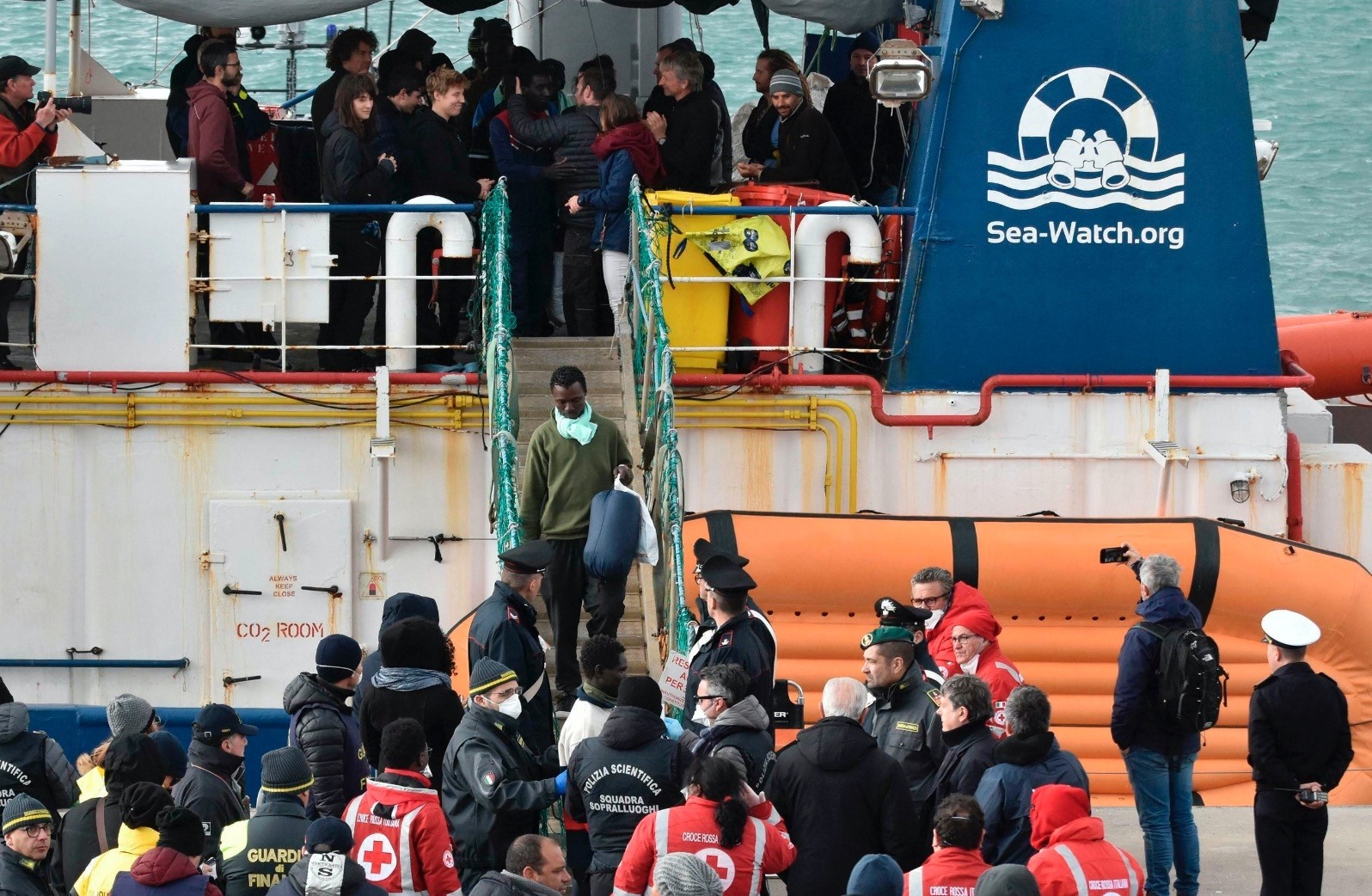 Migrants disembark from the rescue ship Sea-Watch 3 as it docked at the Sicilian port of Catania, Jan. 30, 2019.