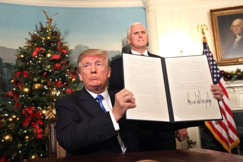 U.S. Vice President Mike Pence watches as U.S. President Donald Trump holds up his proclamation about his controversial decision to formally recognize Jerusalem as the capital of Israel, Washington, Dec. 6. (EPA Photo)