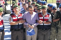 Gendarmeries escort Hakan u00c7iu00e7ek to the courthouse. u00c7iu00e7ek, the owner of a college once controlled by FETu00d6, is accused of coordinating the terrorist group's infiltrators in the military who rose in the ranks to staff officers.