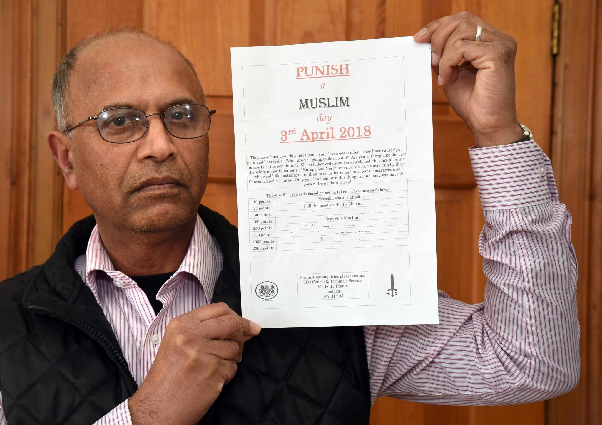 Councillor Riaz Ahmed holds the letter that was sent to him at his business address in Bradford, March 9.