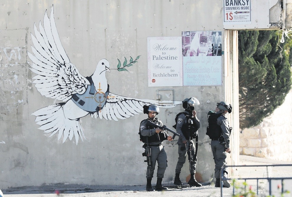 Israeli soldiers stand during clashes with Palestinians in the West Bank city of Bethlehem, Dec. 9. 