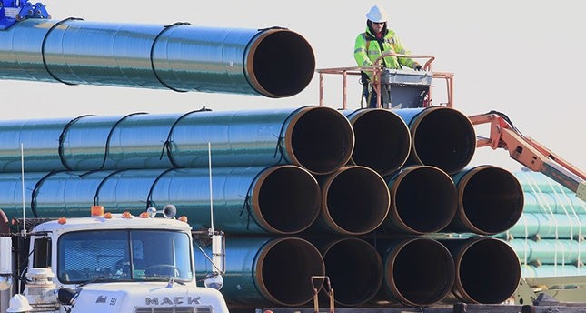  In this May 9, 2015, file photo, workers unload pipes for the proposed Dakota Access oil pipeline that would stretch from the Bakken oil fields in North Dakota to Illinois. (AP Photo) 