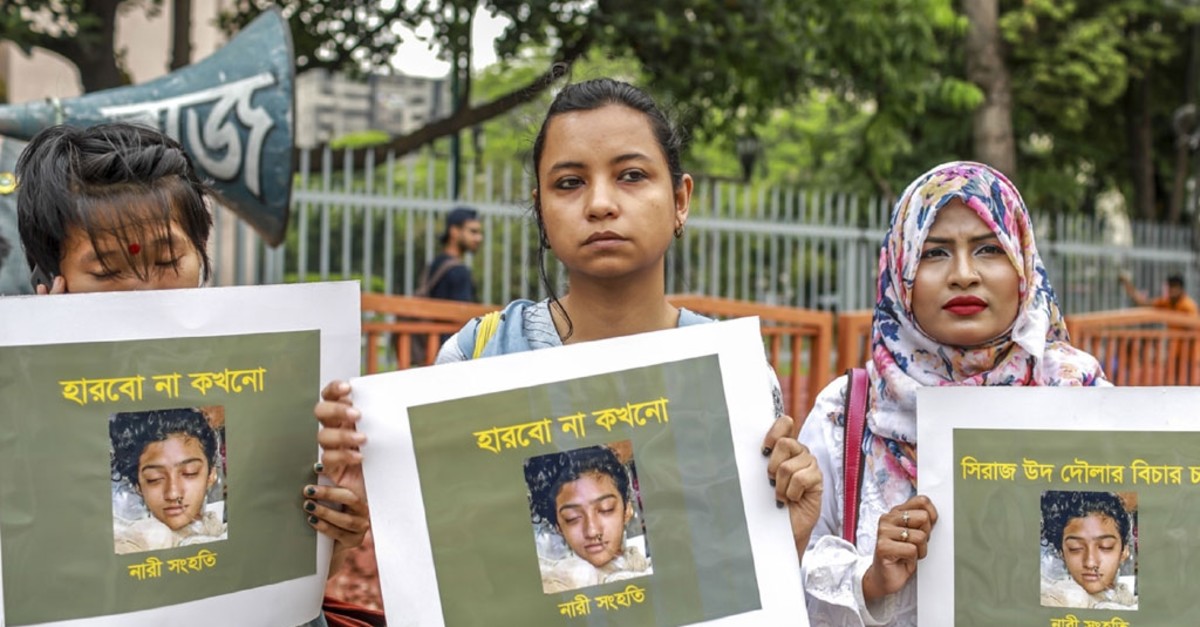 In this photo taken on April 12, 2019 Bangladeshi women hold placards and photographs of schoolgirl Nusrat Jahan Rafi at a protest in Dhaka, following her murder by being set on fire after she had reported a sexual assault. (AFP Photo)