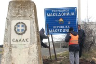 Workers remove a road sign that reads u2018'Republic of Macedonia'' u2013 the other sign reads ,Hellas-Greece, in Greek u2013 on the southern border with Greece, near Gevgelija, Feb. 13, 2019.
