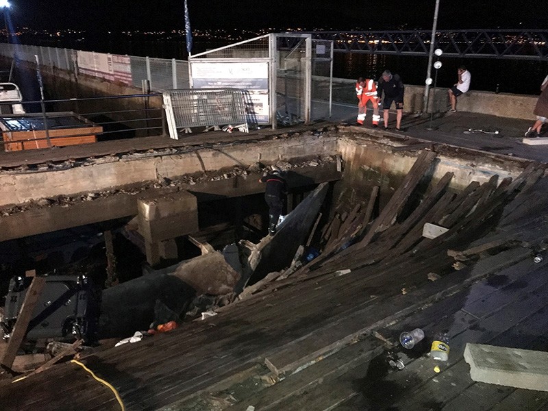 Several firefighters search for victims after several dozens people fell into the sea when a wooden gateway collapsed during a concert in Vigo, northwestern Spain, late at night on Aug. 12, 2018. (EPA Photo)