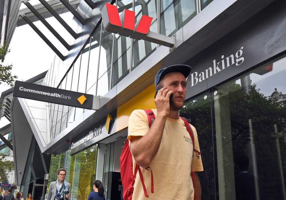 A man walks past a branch of a Westpac and Commonwealth banks in Melbourne, Feb. 4, 2019.