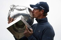 Nicolas Colsaerts of Belgium kisses the trophy after winning the Amundi French Open, at Le Golf National in Saint-Quentin-en-Yvelines, outside Paris, France, Sunday, Oct. 20, 2019. (AP Photo/Thibault Camus)