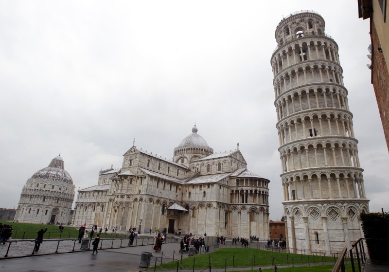 The Leaning Tower of Pisa (Torre di Pisa) is seen at right next to the medieval cathedral of Pisa, in Piazza dei Miracoli Square, in Pisa, Italy, Sunday, Jan. 2, 2012. (AP Photo)