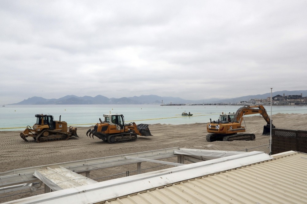 Earth movers enlarge and beautify the beach. (AFP Photo)