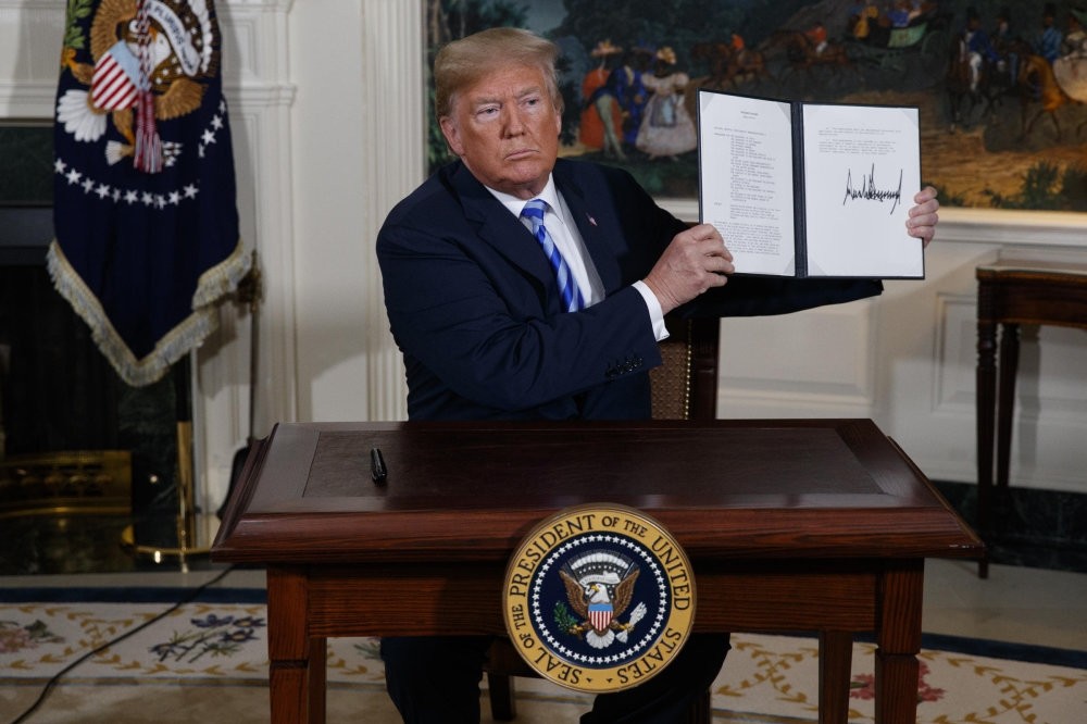 President Trump signs a presidential memorandum on the Iran nuclear deal in the diplomatic reception room of the White House, Tuesday, May 8.