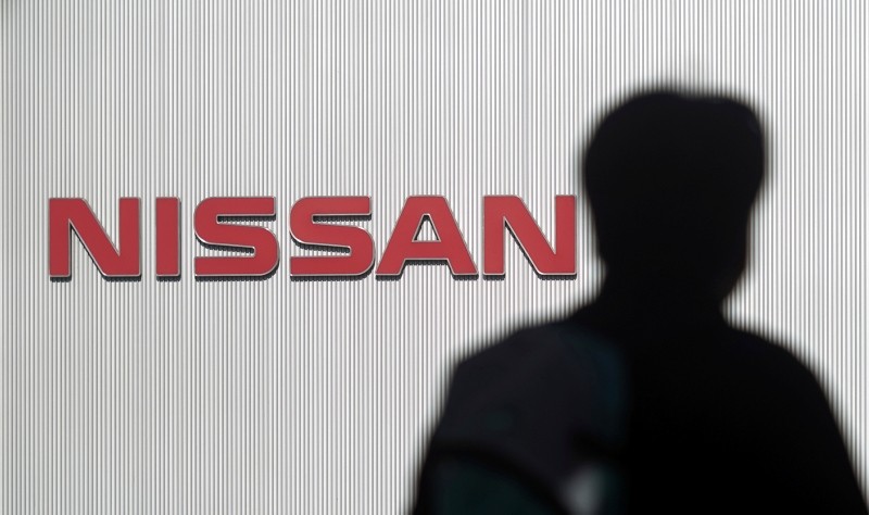 A man walks past the logo of Nissan Motor Co. at Nissan Motor Co. Global Headquarters in Yokohama near Tokyo Wednesday, Nov. 21, 2018. (AP Photo)