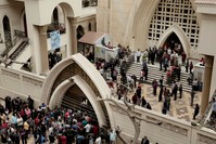 People gather outside St. George's Church after a deadly suicide bombing in the Nile Delta town of Tanta, Egypt, April 9.