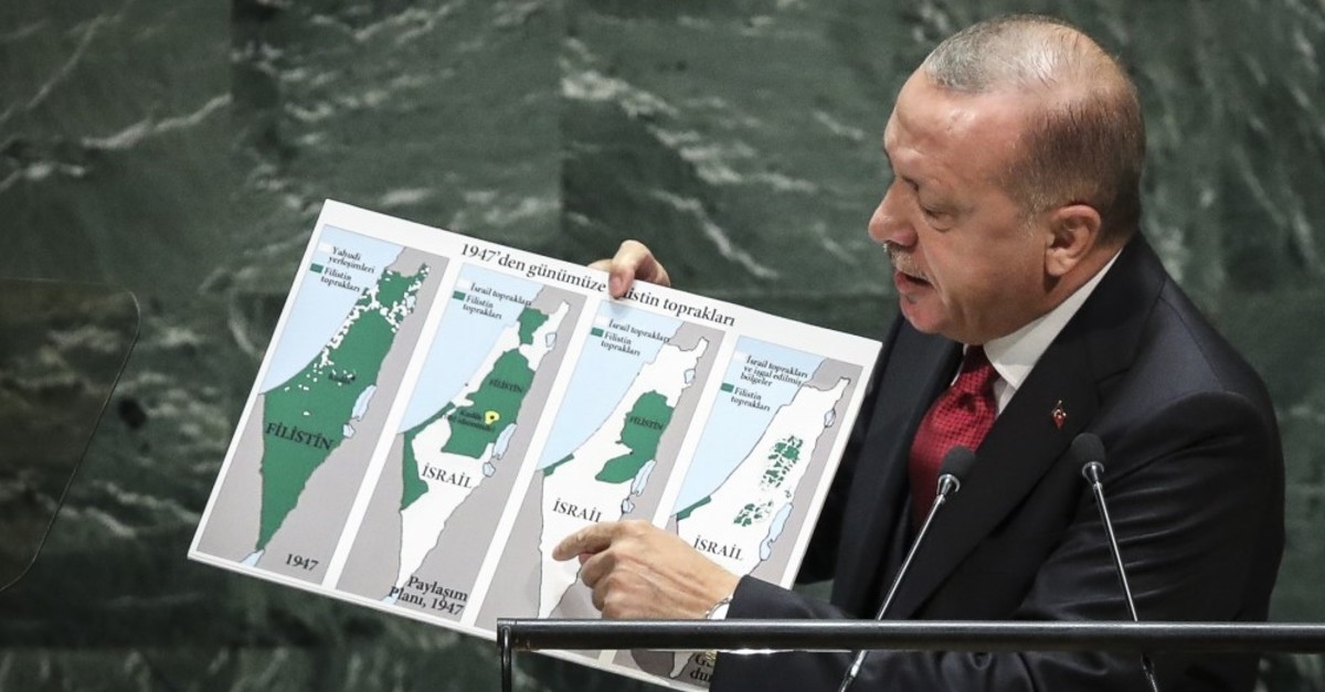 President Recep Tayyip Erdou011fan holds up a map of Palestine since 1947 showing changing population and territory under Israeli rule while speaking at U.N. headquarters in New York, Sept. 24, 2019