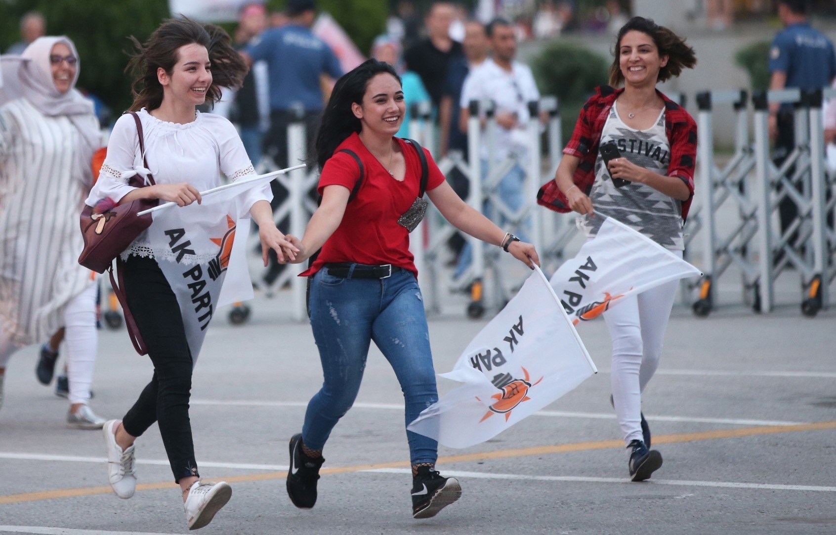 Supporters of President Recep Tayyip Erdou011fan hold Turkish and AK Party flags and greet after closing voting for the Turkish presidential and parliamentary elections in Ankara, 24 June.