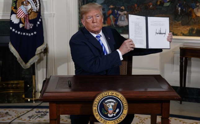 President Trump shows a signed presidential memorandum reinstating US nuclear sanctions on the Iranian regime on May 8, 2018. Evan Vucci/AP